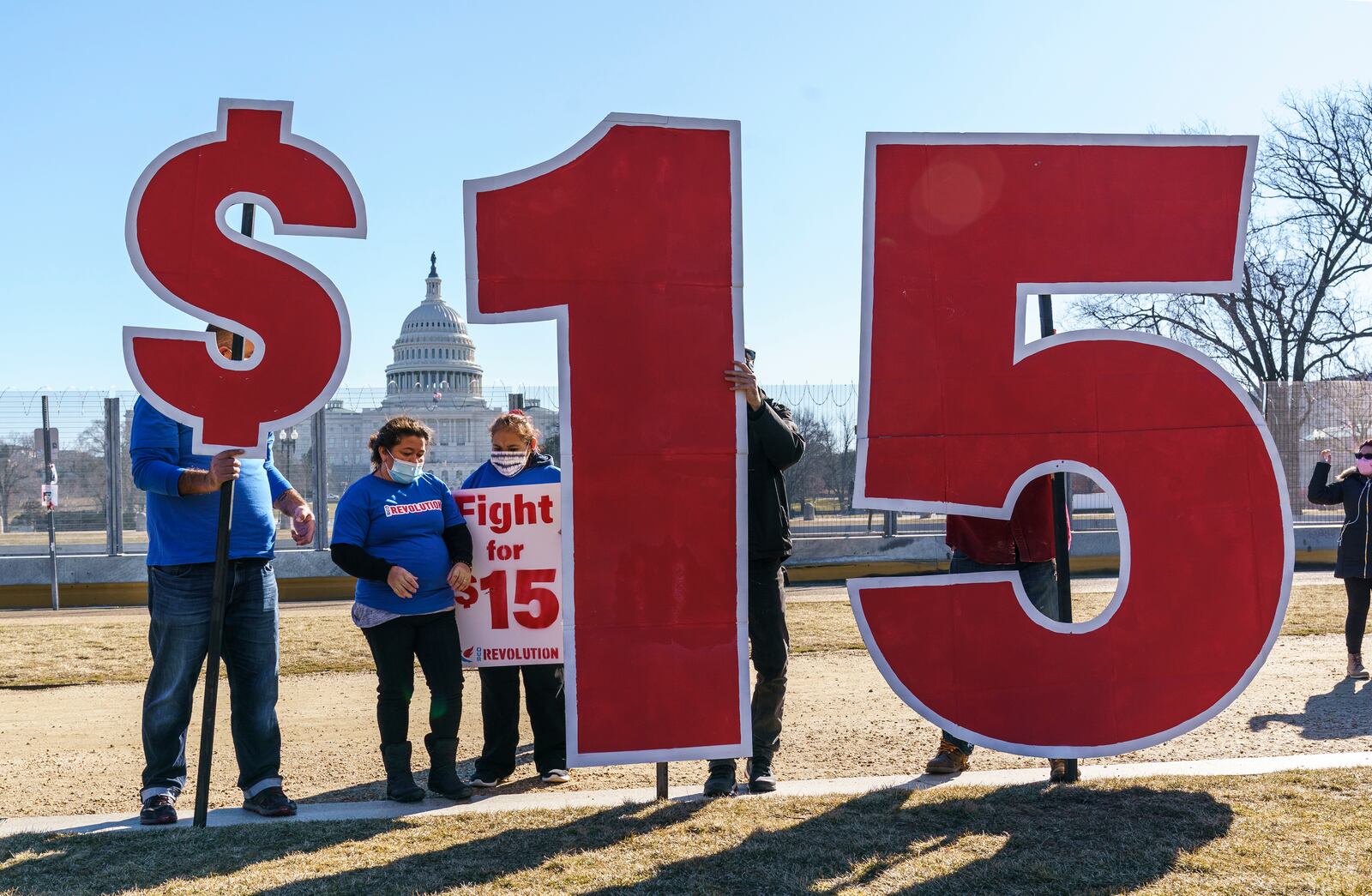 FILE - Activists appeal for a $15 minimum wage near the Capitol in Washington, Thursday, Feb. 25, 2021. According to the Economic Policy Institute, the federal minimum wage in 2021 was worth 34% less than in 1968, when its purchasing power peaked. (AP Photo/J. Scott Applewhite, File)