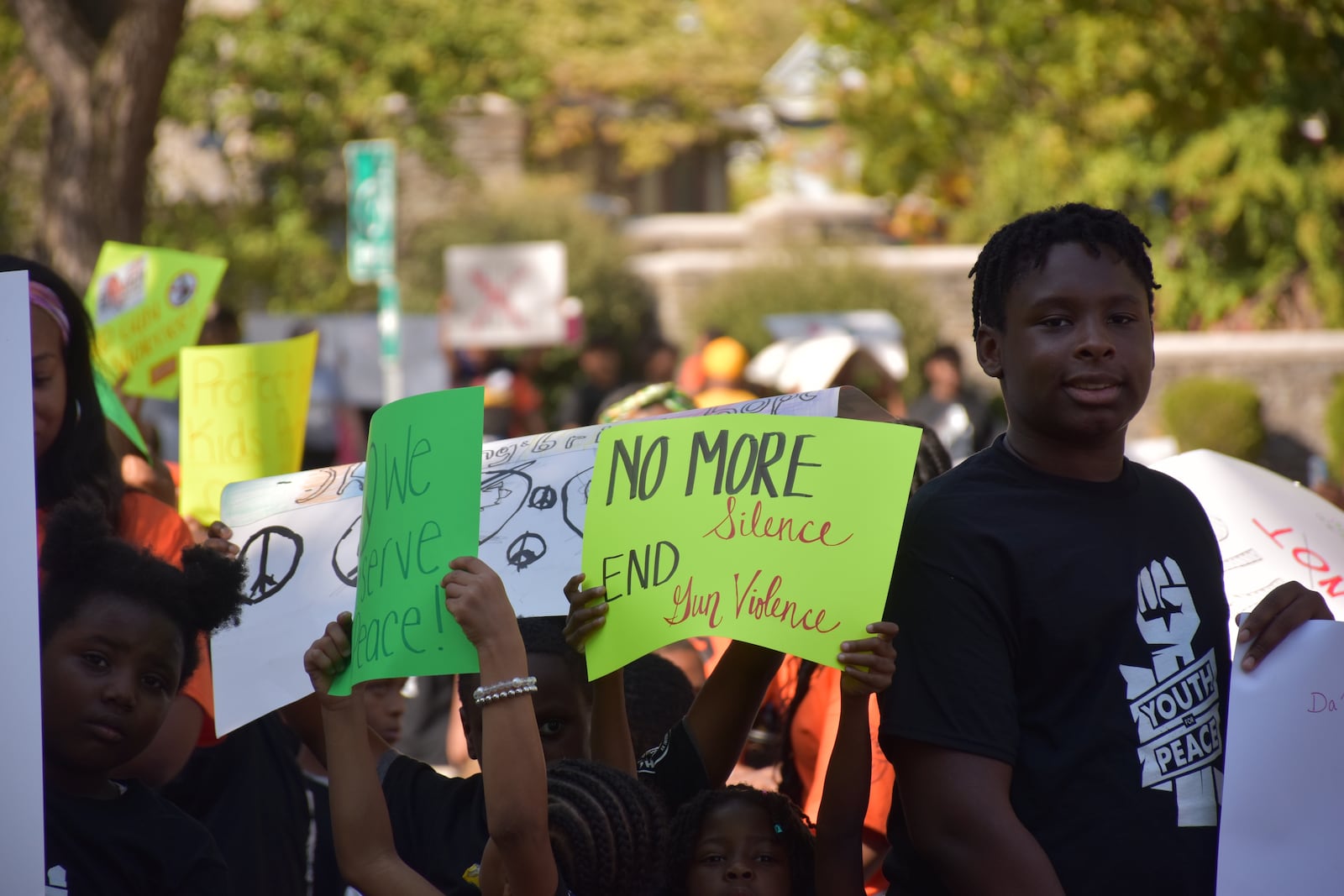 Kids, teens and adults marched down Broadway Street in northwest Dayton in September as part of a peace march and rally in response to an increase in gun violence in the community. CORNELIUS FROLIK / STAFF