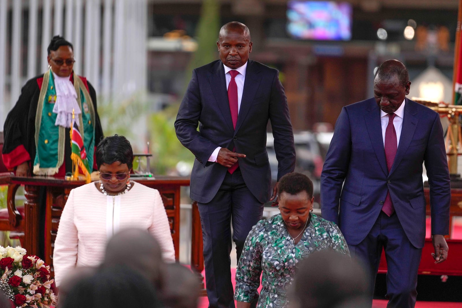 Kenya's new Deputy President Kithure Kindiki, center, walks from the podium with Kenyan President William Ruto, right, after he was sworn-in office at a ceremony held at Kenyatta International Convention Centre, in Nairobi, Kenya Friday, Nov. 1, 2024. (AP Photo/Brian Inganga)