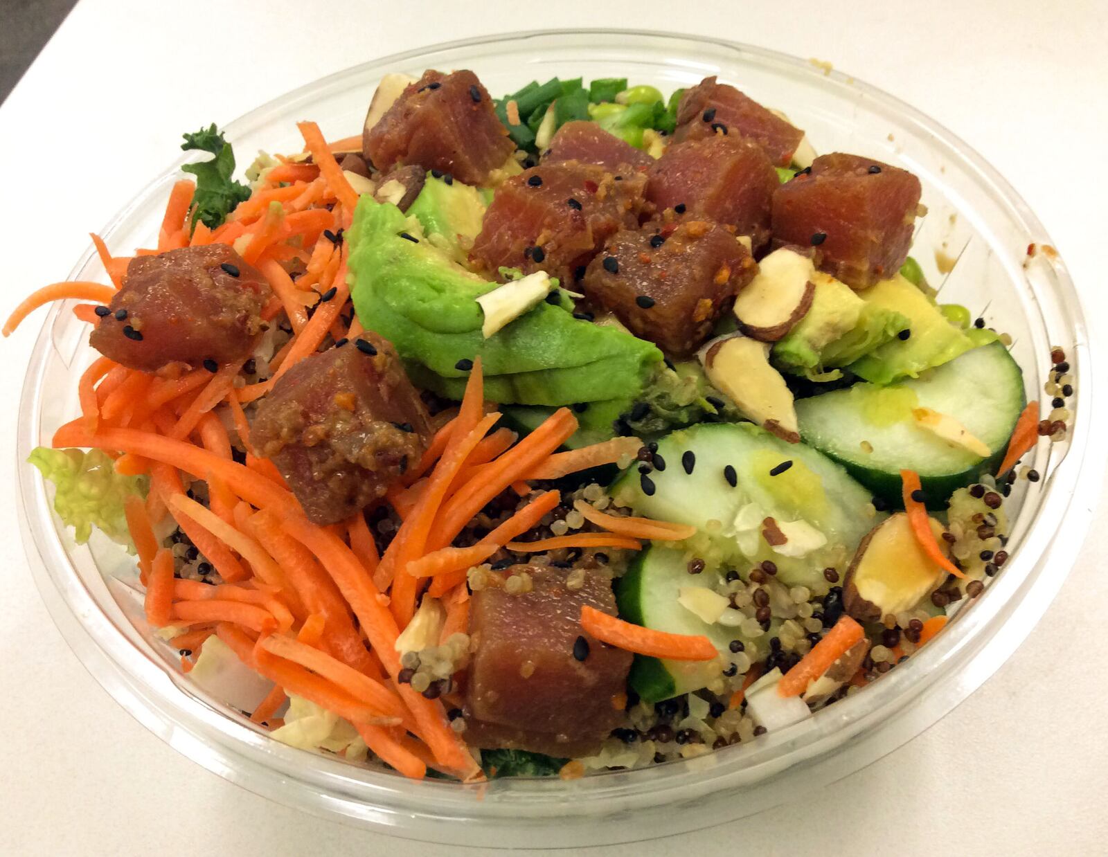 The Tuna Poke grain bowl featured poke ­ahi tuna, cabbage, cucumber, quinoa, carrots, scallions, avocado, kale, almonds, sesame seeds, edamame. We tried it with the suggested with miso sesame ginger dressing. MARK FISHER / STAFF