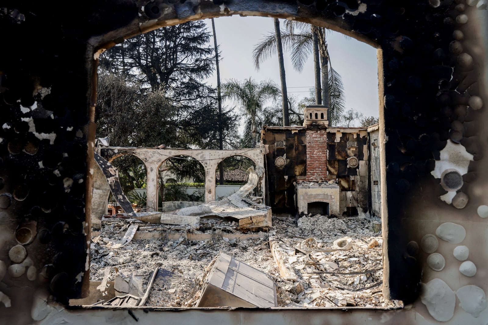 The charred home of Demmi Choo, 31, and her husband Gene Huang Lee, 32, can be seen off Braeburn Road in Altadena, Calif. on Friday, Jan. 10, 2024. Choo and her husband were out of the country when they received the news that flames from the Eaton Fire destroyed their home. The couple moved to the Altadena neighborhood in 2021. "We bought a house, and then we got married that year," said Choo. "We were so excited, because it's our first home together…It was going to be our forever home."(Brontë Wittpenn/San Francisco Chronicle via AP)