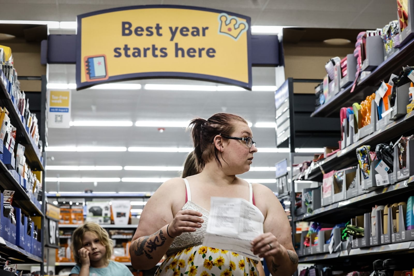 Ashleigh Rutledge, from Dayton, shops for school supplies with her stepdaughters Mary and Aubree at the Walmart in Beavercreek Thursday July 25, 2024. This year, Ohio sales tax holiday starts at midnight Tuesday, July 30, and runs 10 days instead of 3 days. JIM NOELKER/STAFF