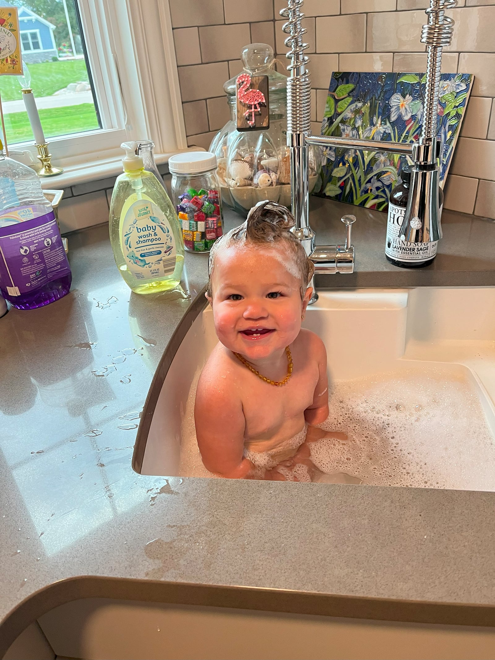 Granddaughter Eleanor take a bath in the sink of the Wakers' new kitchen.