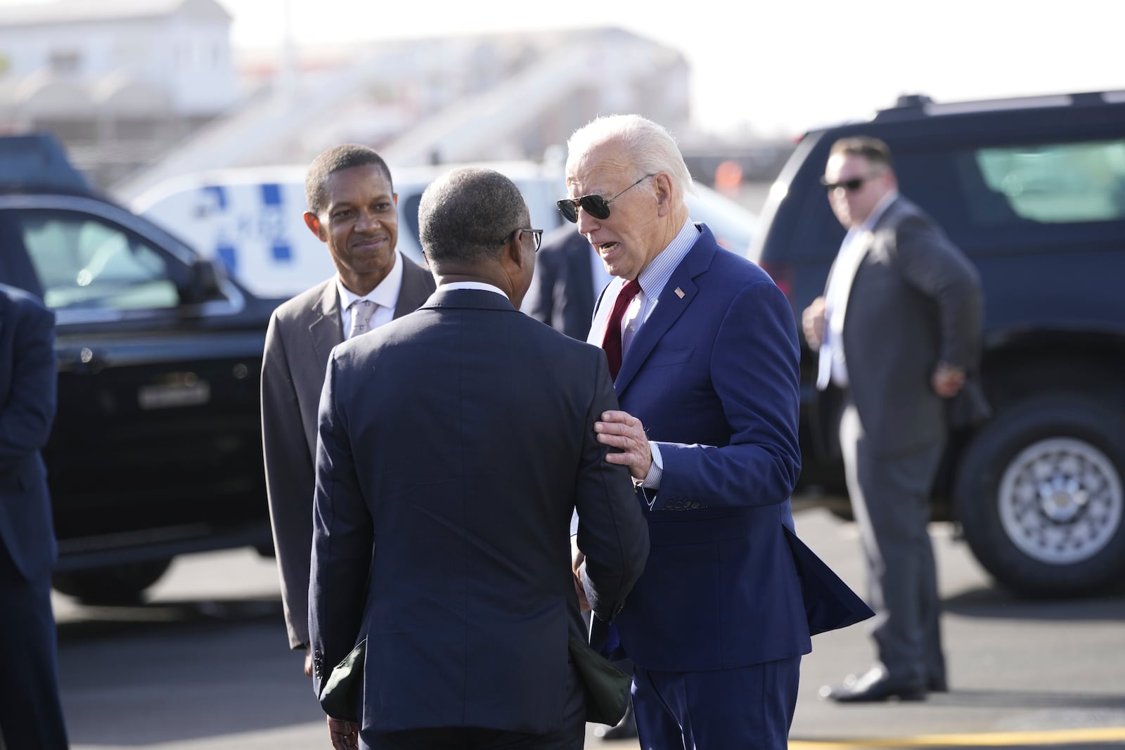 With Jose Luis Livramento, Cabo Verde Ambassador to the U.S looking on, President Joe Biden is greeted by Cape Verde's Prime Minister Ulisses Correia e Silva at Amilcar Cabral international airport on Sal island, Cape Verde Monday, Dec. 2, 2024, en route to Angola as he makes his long-promised visit to Africa. (AP Photo/Ben Curtis)