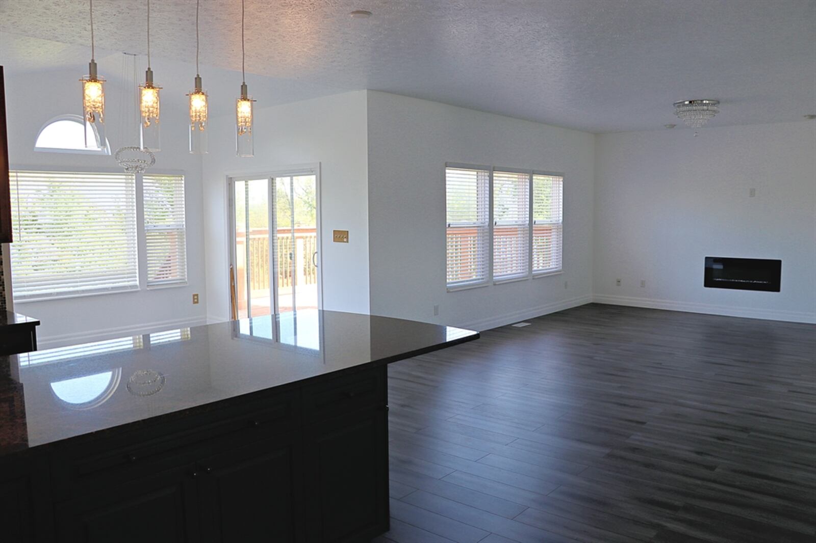 The morning room has a cathedral ceiling and sliding patio doors that open to the wooden balcony deck.