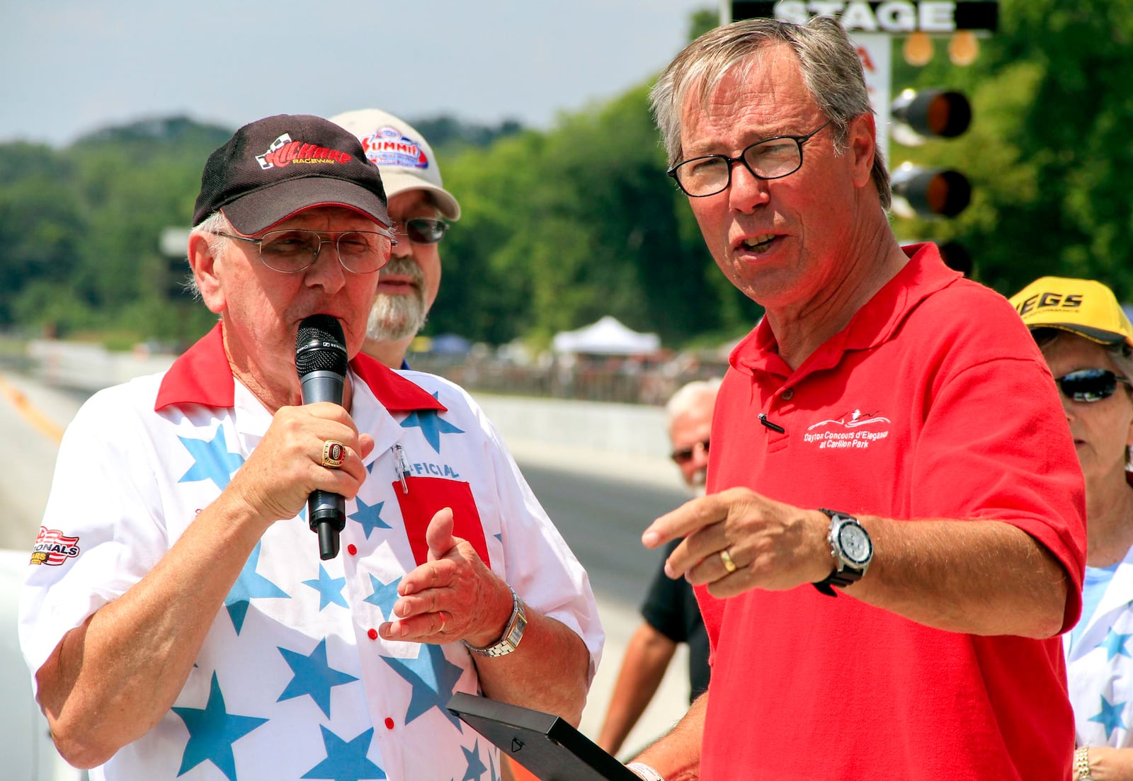 Skip Peterson, right, is introduced by Ed Crowder, left, as the grand marshal of the 5th Gathering of the Geezers on Aug. 17 at Kil-Kare Speedway and Dragway. Peterson was chosen as grand marshall in recognition of his many contributions to the Dayton car community. Contributed by Jennifer Peterson