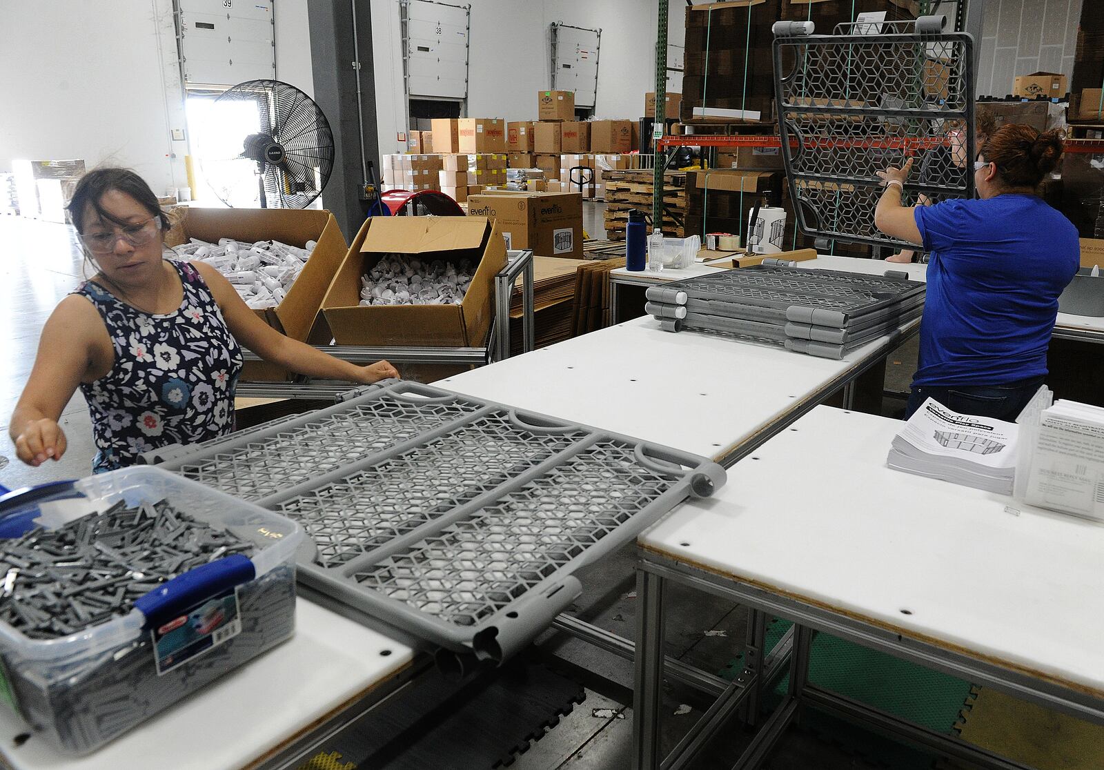 Employees of Innovative Plastic Molders assemble babygates. The company manufactures all the plastic parts in house. MARSHALL GORBY\STAFF