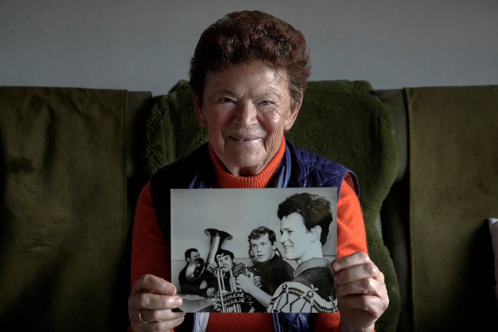 Solveig Leo, 81, former head of a large state-owned farm shows an old photo of herself from her youth during her interview with the Associated Press in the northeastern village of Banzkow, Germany, Monday, Oct. 28, 2024. (AP Photo/Ebrahim Noroozi)