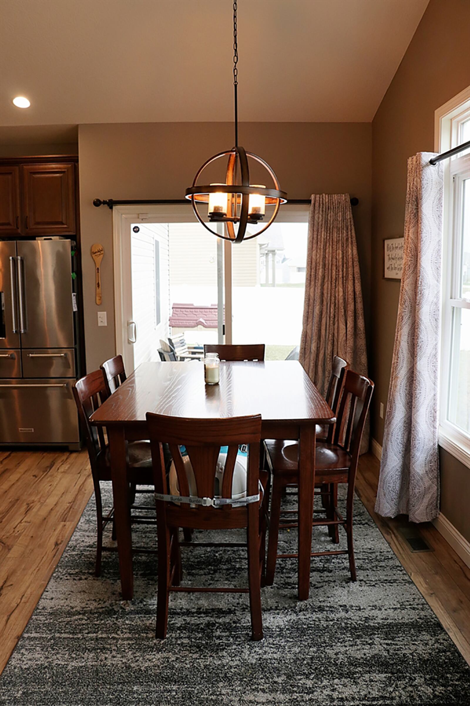 Sliding patio doors off the dining area open to a long concrete patio and the fenced back yard. Sharing the dining room and great room area, a wall of windows fills all three rooms with plenty of natural light and views of the back yard. CONTRIBUTED PHOTO BY KATHY TYLER