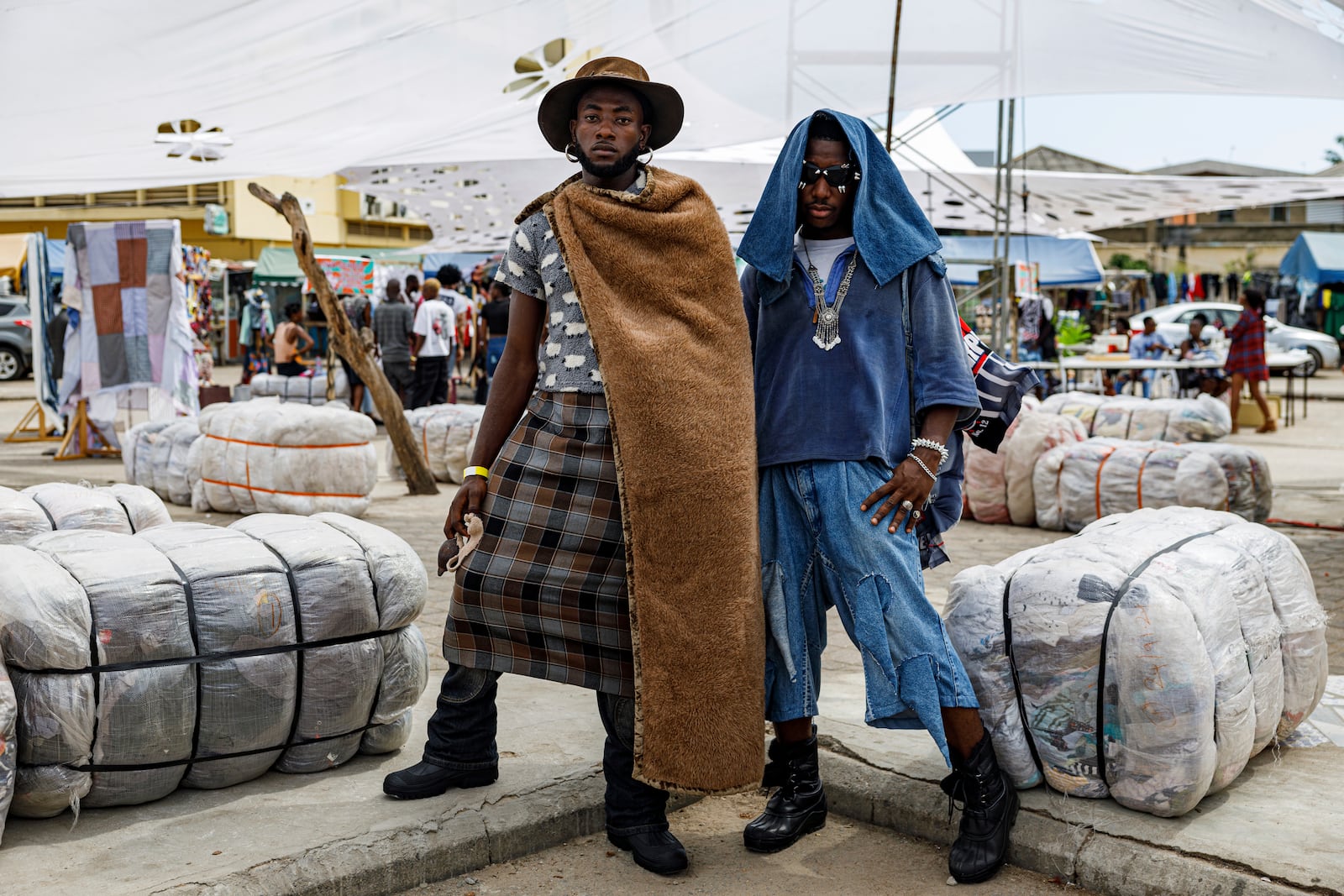 Attendees pose for a photograph during a thrift and an upcycle show in Accra, Ghana, Sunday, Oct. 27, 2024. (AP Photo/Misper Apawu)