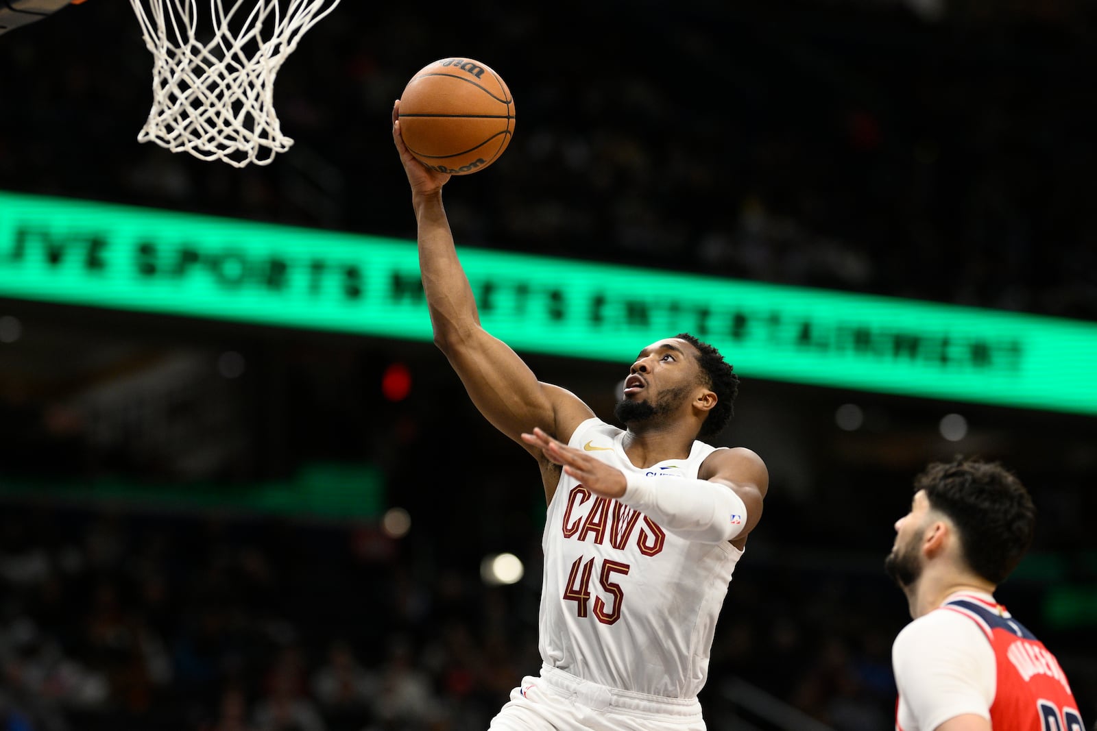 Cleveland Cavaliers guard Donovan Mitchell (45) goes to the basket past Washington Wizards forward Tristan Vukcevic, right, during the first half of an NBA basketball game, Friday, Feb. 7, 2025, in Washington. (AP Photo/Nick Wass)