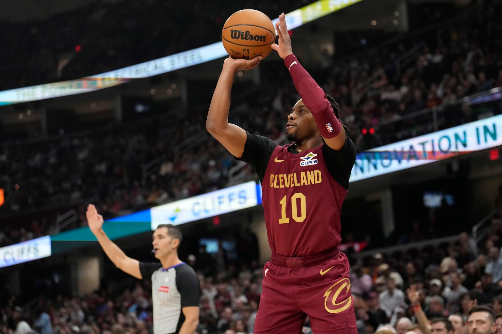 Cleveland Cavaliers guard Darius Garland (10) shoots a three-point-basket in the first half of an NBA basketball game against the Milwaukee Bucks, Monday, Nov. 4, 2024, in Cleveland. (AP Photo/Sue Ogrocki)