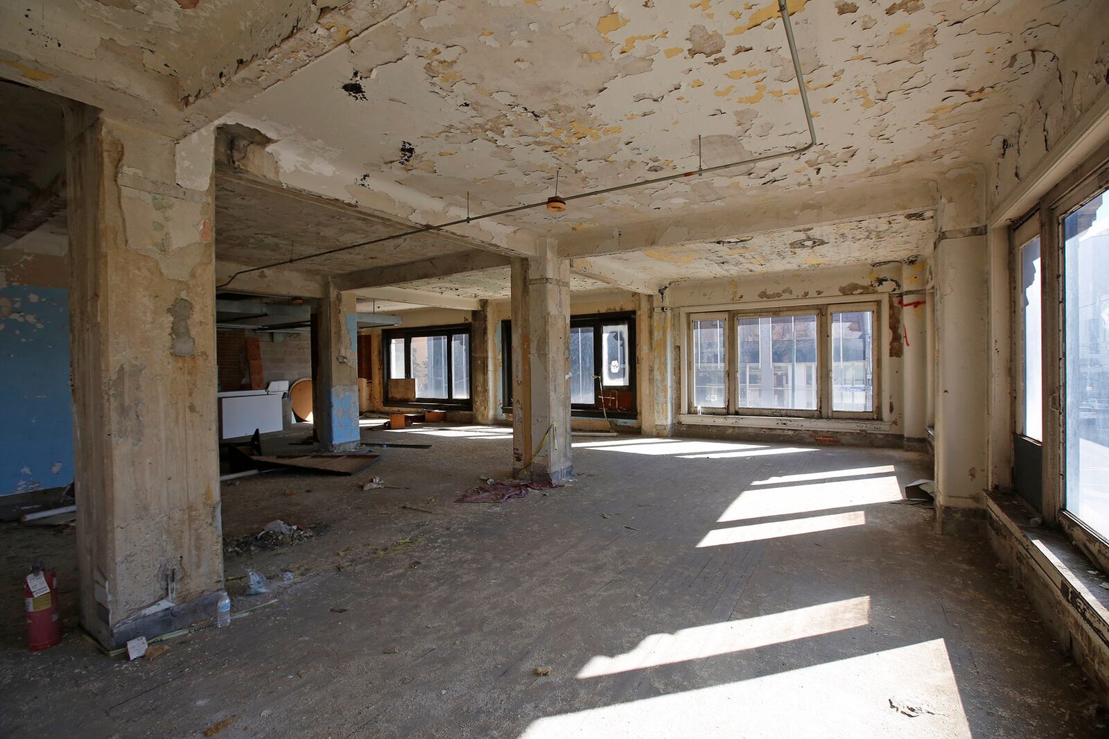 The Commercial building at the corner of Fourth and Ludlow Streets features an ornate staircase with wrought iron, marble treads, landings and wainscoting and quartern-sawn oak handrail.  Chicago-style windows fill the outside walls of office and living space.  This building is also part of the phase one renovation of the Dayton Arcade.   TY GREENLEES / STAFF