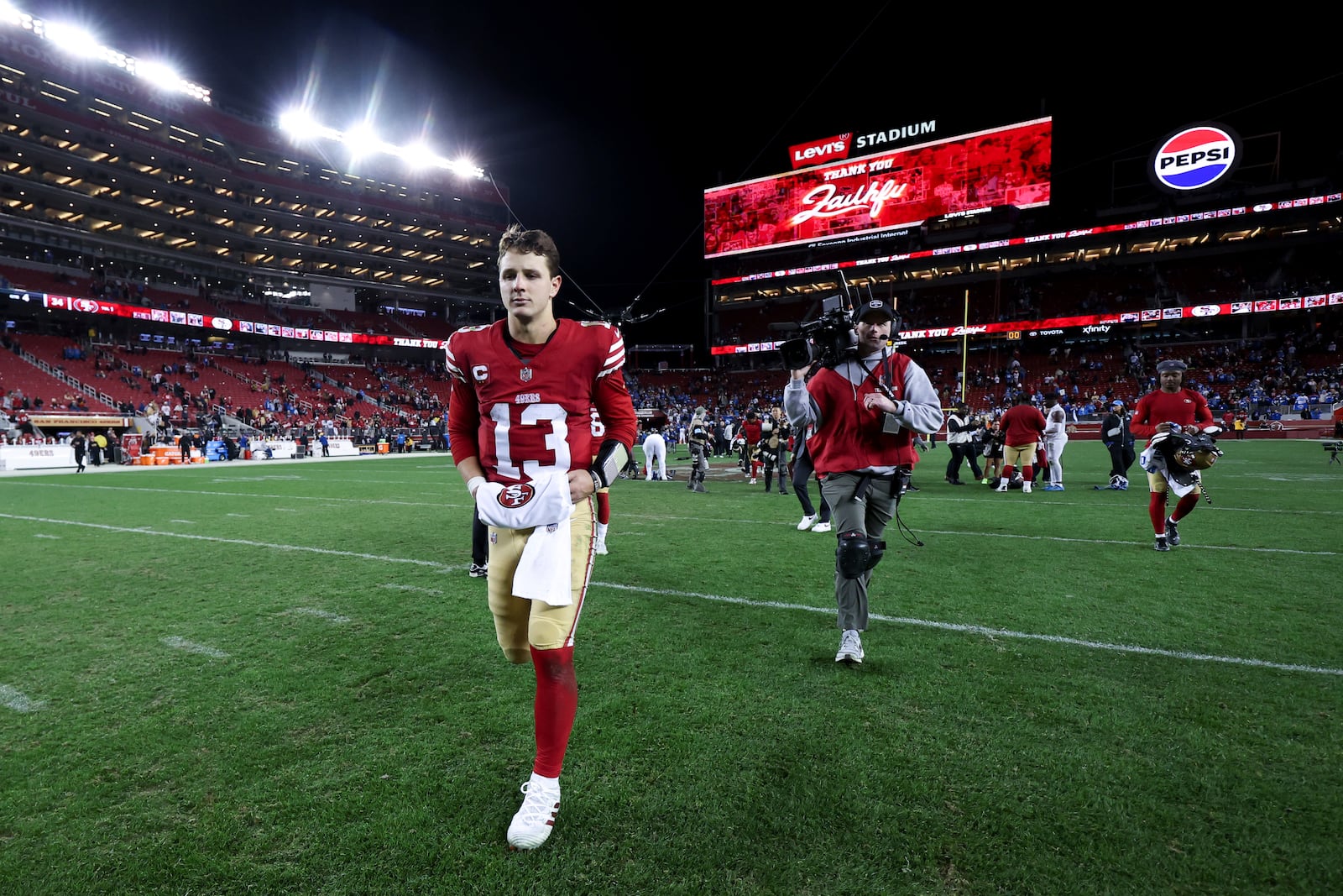 San Francisco 49ers quarterback Brock Purdy (13) walks off the field after a loss to the Detroit Lions in an NFL football game Monday, Dec. 30, 2024, in Santa Clara, Calif. (AP Photo/Jed Jacobsohn)