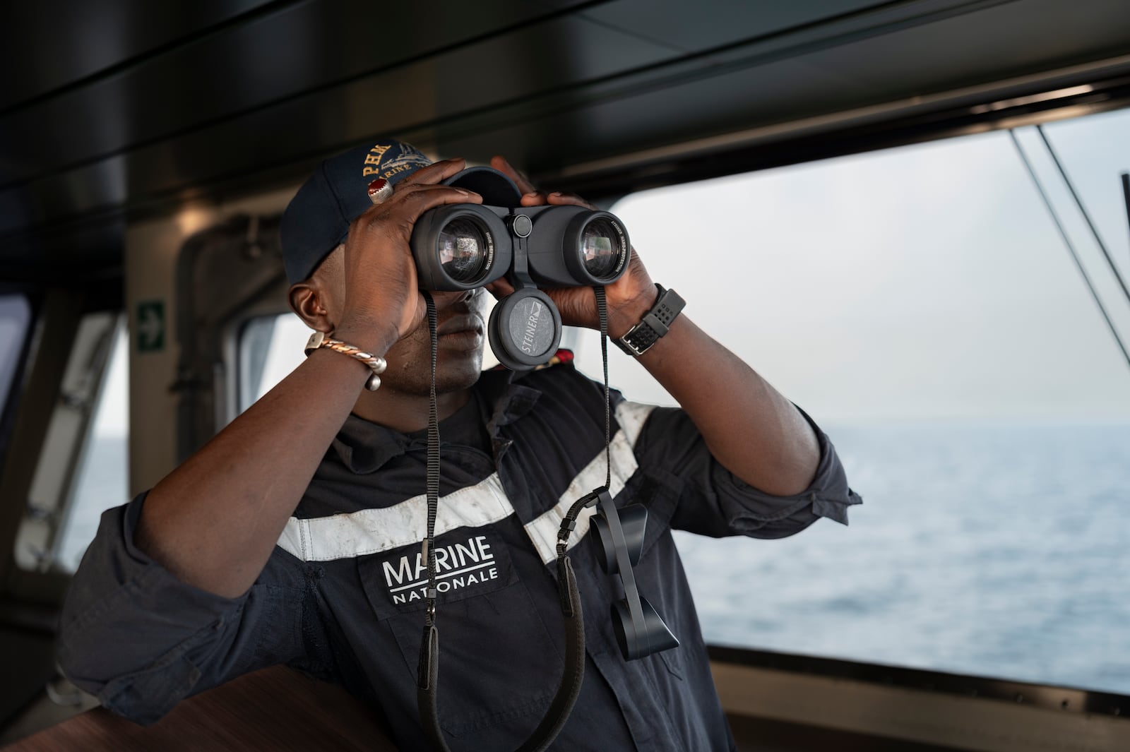 A Senegalese sailor surveys the sea on the patrol vessel Niani during a mission to search for illegal migrant boats near the coast of Dakar, Senegal, Saturday, Nov.16, 2024. (AP Photo/Sylvain Cherkaoui)