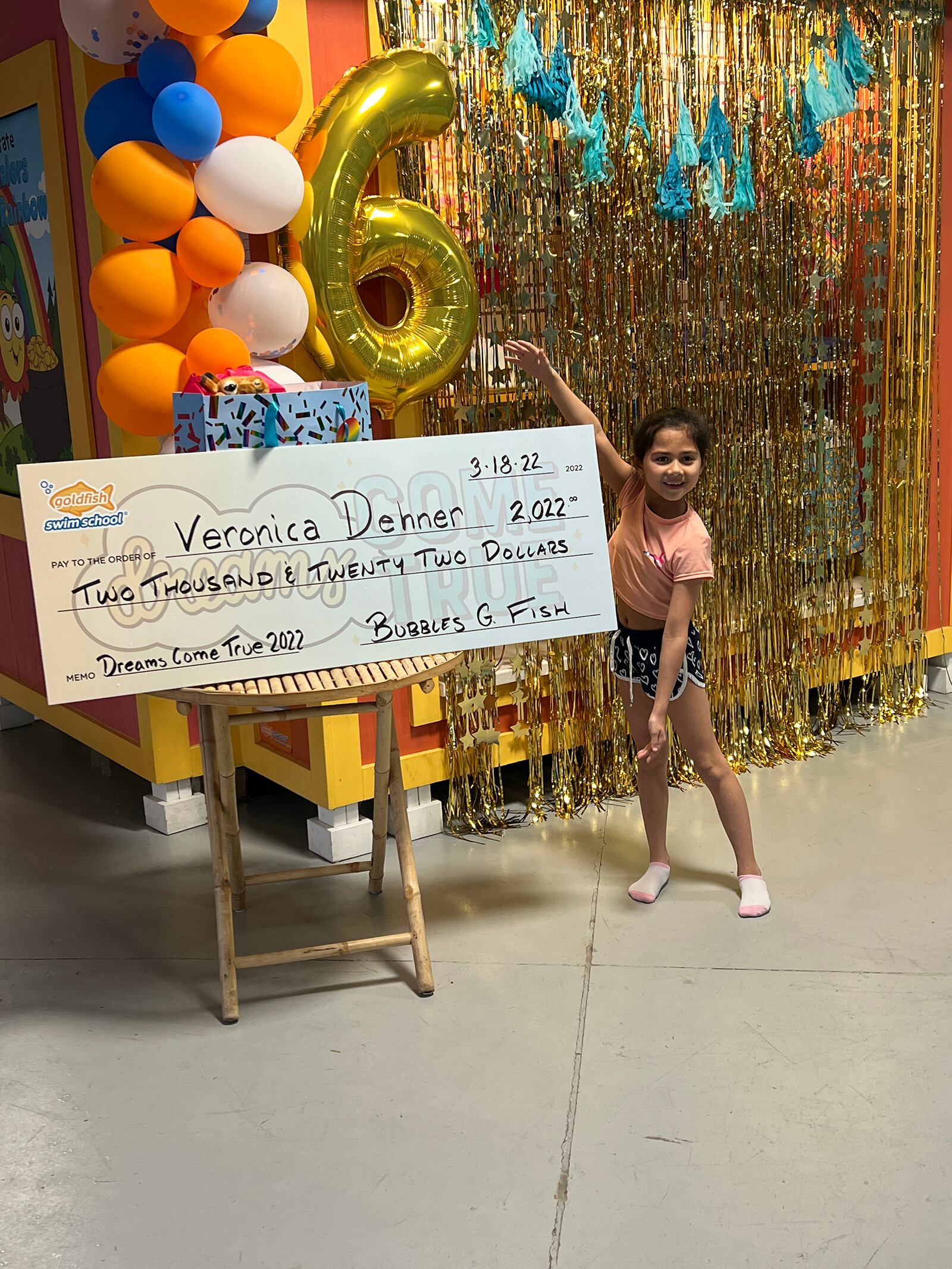 Veronica Dehner with her ceremonial giant check, presented on the local Goldfish Swim School's 6th birthday in Centerville. Veronica was one of only two swim school students nationwide to receive the prize. CONTRIBUTED