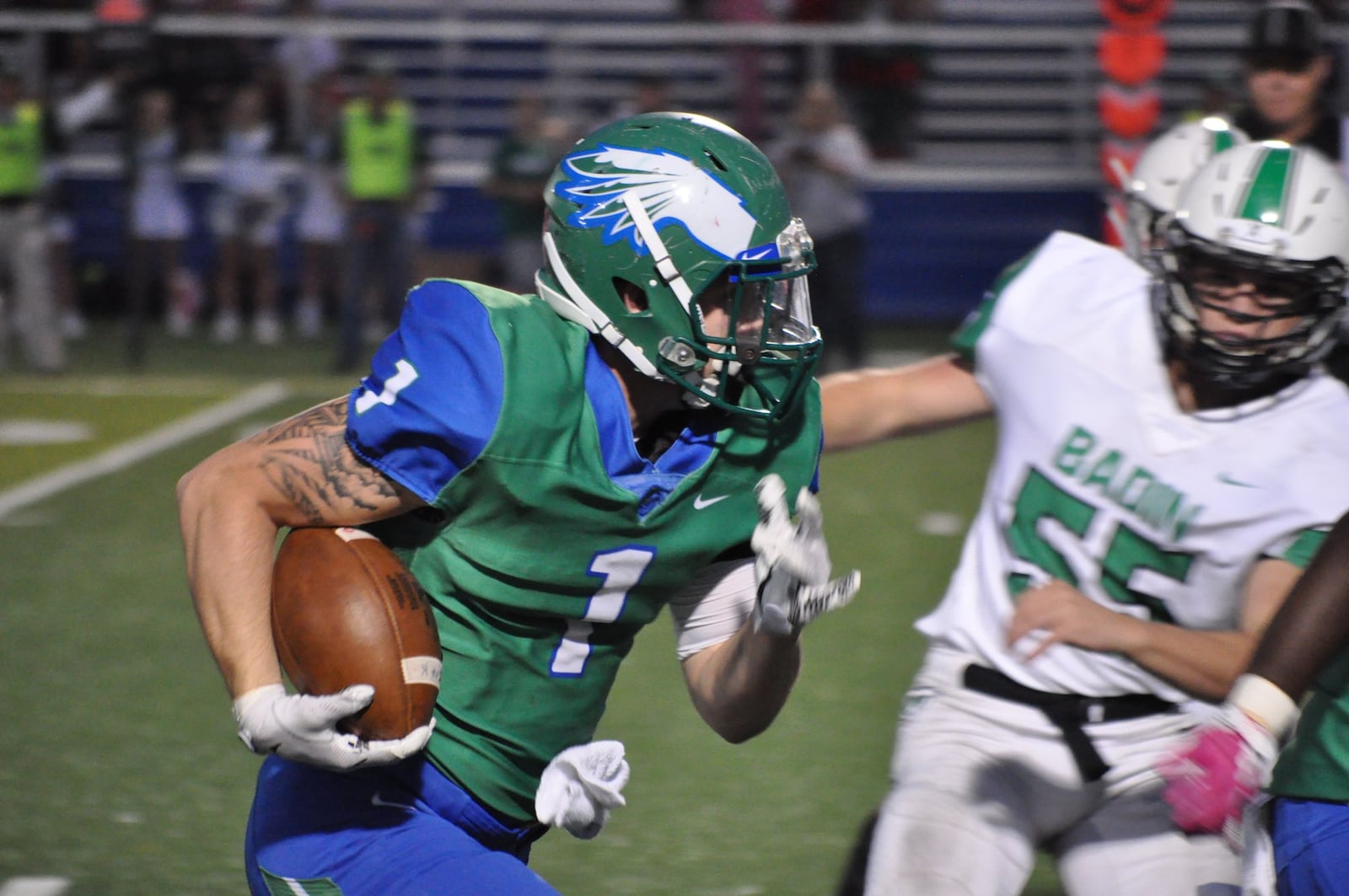 Chaminade Julienne’s Jonathan Bell looks to get past Bryan Henson (55) of Badin on Friday night at Roger Glass Stadium in Dayton. CONTRIBUTED PHOTO BY NICK DUDUKOVICH