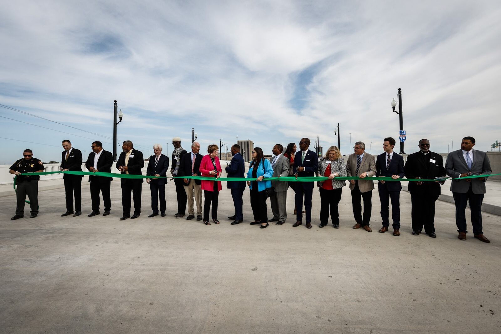 It took three ribbon cutting to get everyone who was involved in the construction of the new Third Street Peace bridge. JIM NOELKER/STAFF