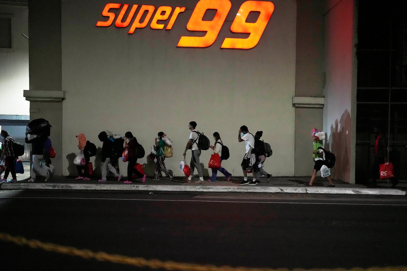 Migrants, mostly from Asian countries, arrived in Panama City on Saturday, March 8, 2025, after spending weeks in a temporary Panamanian immigration camp following their deportation from the U.S. and being released on the condition that they leave the country within 30 days. (AP Photo/Matias Delacroix)