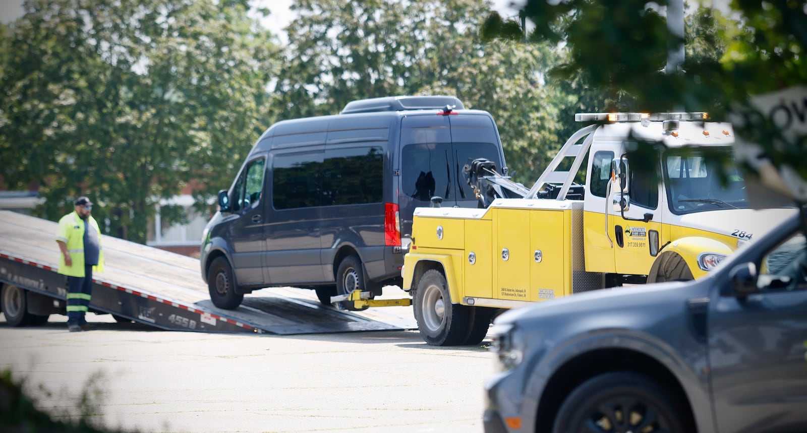 Several small buses were loaded onto flatbed trailers and removed Friday, July 26, 2024 from Fuyao Glass America in Moraine. MARSHALL GORBY\STAFF