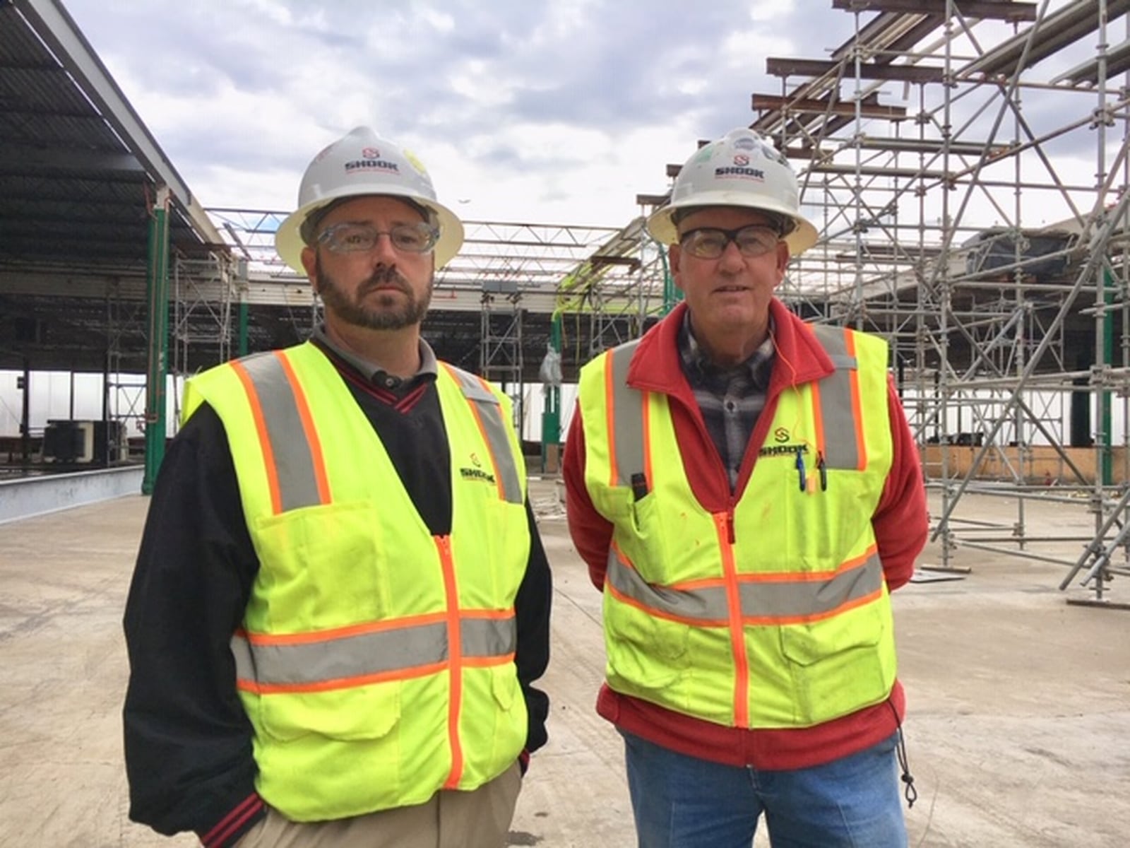 From the left, Tim Knueve, vice president of industrial at Shook Construction Co., and Larry “Moe” Mileski, Shook superintendent, say that in their decades of experience, they have never faced a job as big or complex as the rebuilding of Dayton Phoenix Group’s Kuntz Road plant. Rebuilding a devastated 640,000-square-foot plant is more complicated than building anew, Mileski said. THOMAS GNAU/STAFF