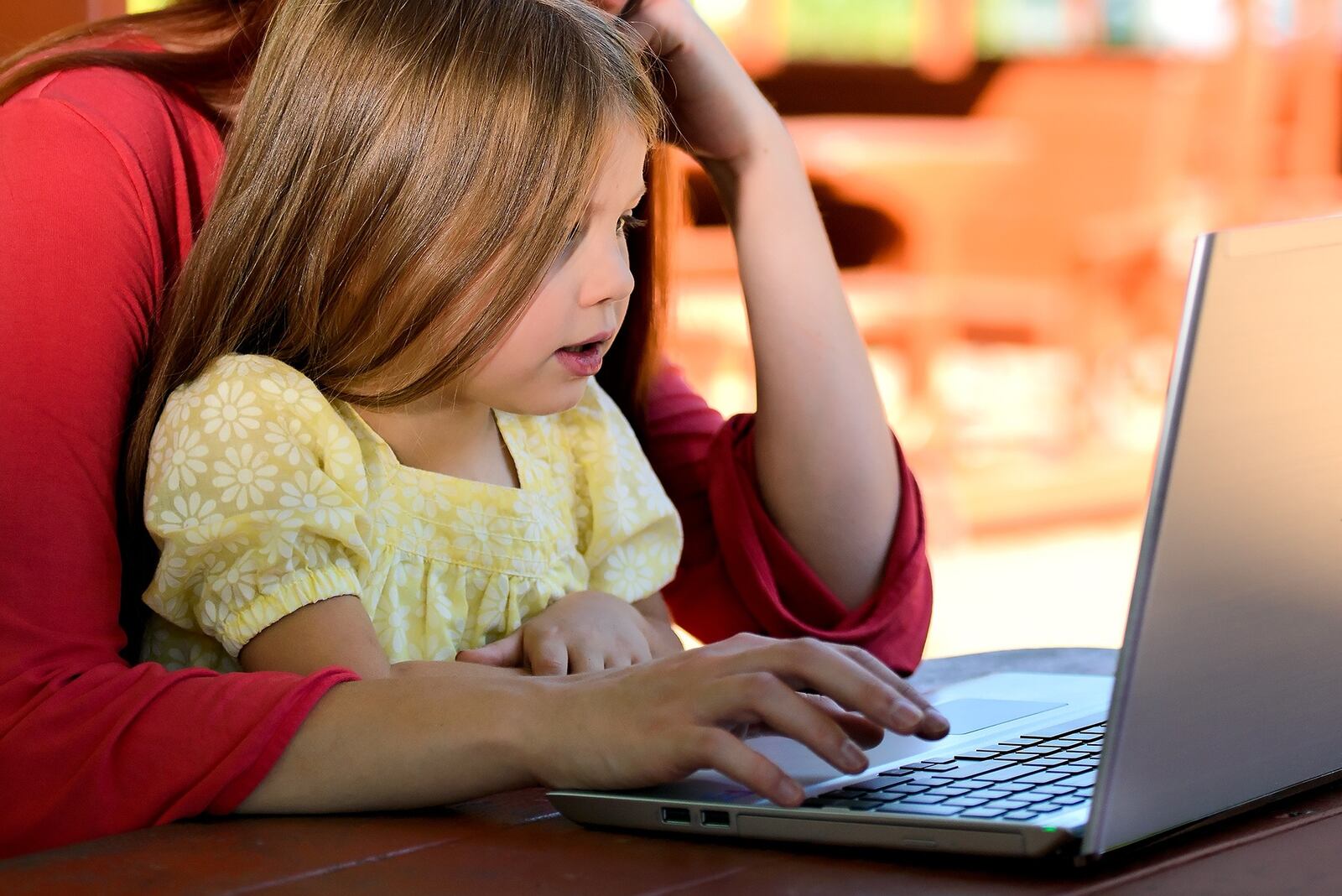 Photo illustration of a child looking at a computer screen.