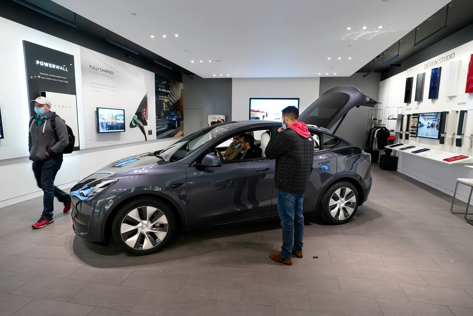 A Tesla Model Y Long Range is displayed at the Tesla Gallery on Feb. 24, 2021, in Troy, Mich. Opinion polls show that most Americans would consider an EV if it cost less, there were more charging stations along freeways, and if automakers offered a bigger variety of models. (AP Photo/Carlos Osorio)