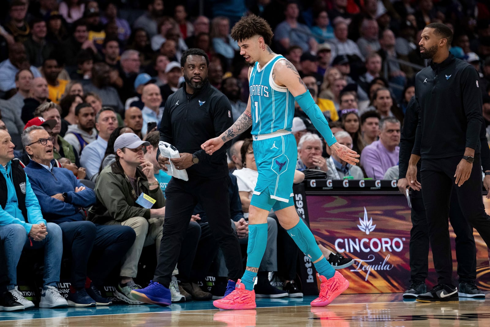 Charlotte Hornets guard LaMelo Ball (1) walks off the court and and to the locker room after tripping during the first half of an NBA basketball game against the Los Angeles Lakers, Monday, Jan. 27, 2025, in Charlotte, N.C. (AP Photo/Jacob Kupferman)