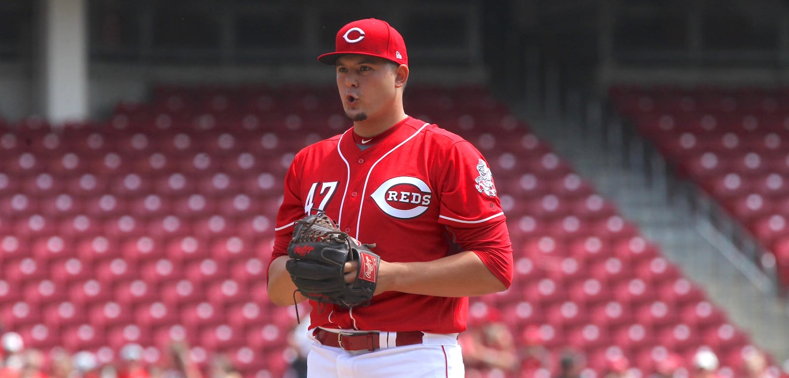 Reds starter Sal Romano prepares to throw his first pitch in the big leagues against the Brewers on Sunday, April 16, 2017, at Great American Ball Park in Cincinnati. David Jablonski/Staff