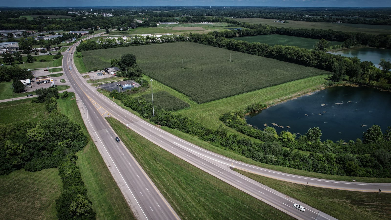 Buc-ee's plans to build a 74,000-square-foot store and fueling center on the land at the right side of this photo, the east side of Ohio 235 in Huber Heights. The ramp splitting off at bottom right is the ramp from Interstate 70 westbound. The road coming in from the left side of this aerial photo is Artz Road. JIM NOELKER/STAFF