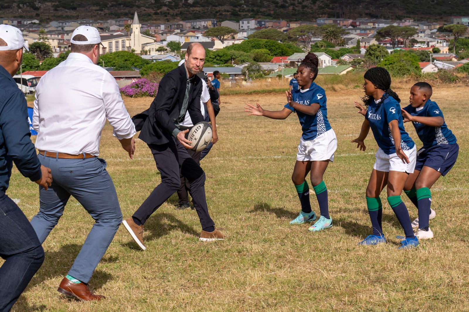 Britain's Prince William plays rugby with pupils at the Ocean View Secondary School in Cape Town, South Africa, Monday, Nov. 4, 2024. (AP Photo/Jerome Delay-pool)