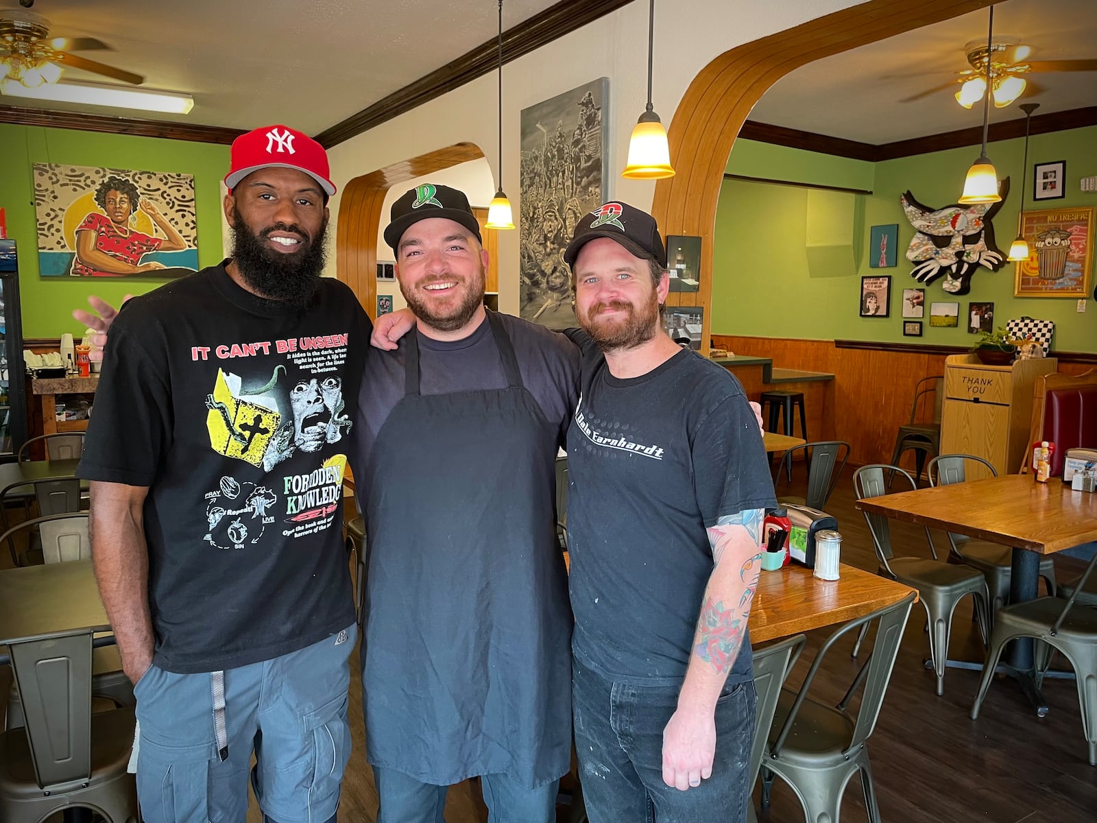 The Ugly Duckling has reopened in a new location at 1430 E. Fifth St. in Dayton’s St. Anne’s Hill Historic District. Pictured (left to right) are owners Dexter Clay, also known as “Uncle Boof,” Zach Jeckering and Mason Schindler. NATALIE JONES/STAFF