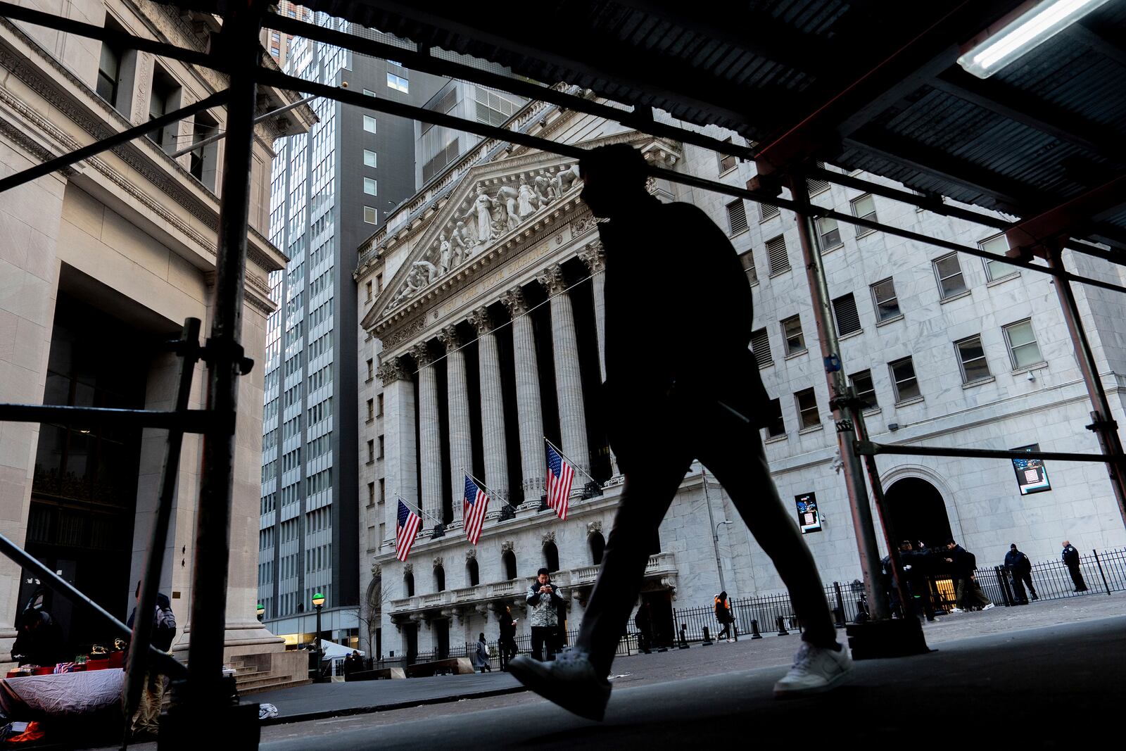 People walk past the New York Stock Exchange, Tuesday, Jan. 28, 2025, in New York. (AP Photo/Julia Demaree Nikhinson)