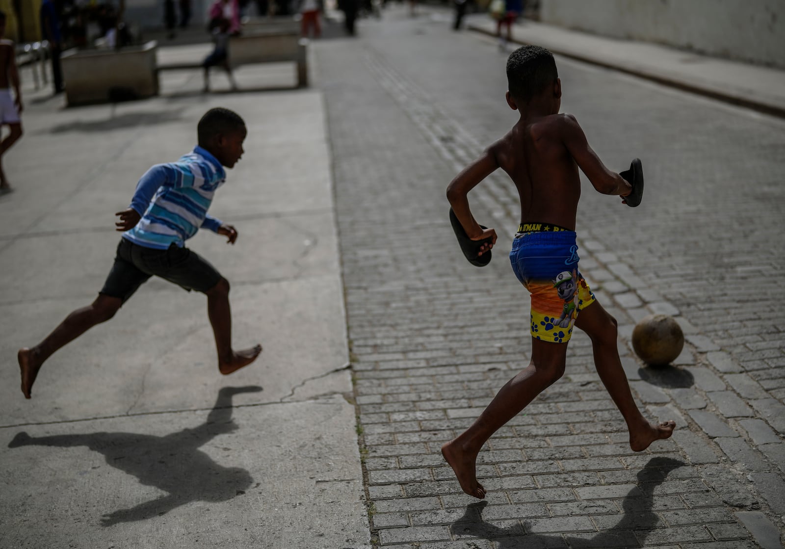 Children kick a ball around during a power outage in Havana, Cuba, Wednesday, Dec. 4, 2024. (AP Photo/Ramon Espinosa)