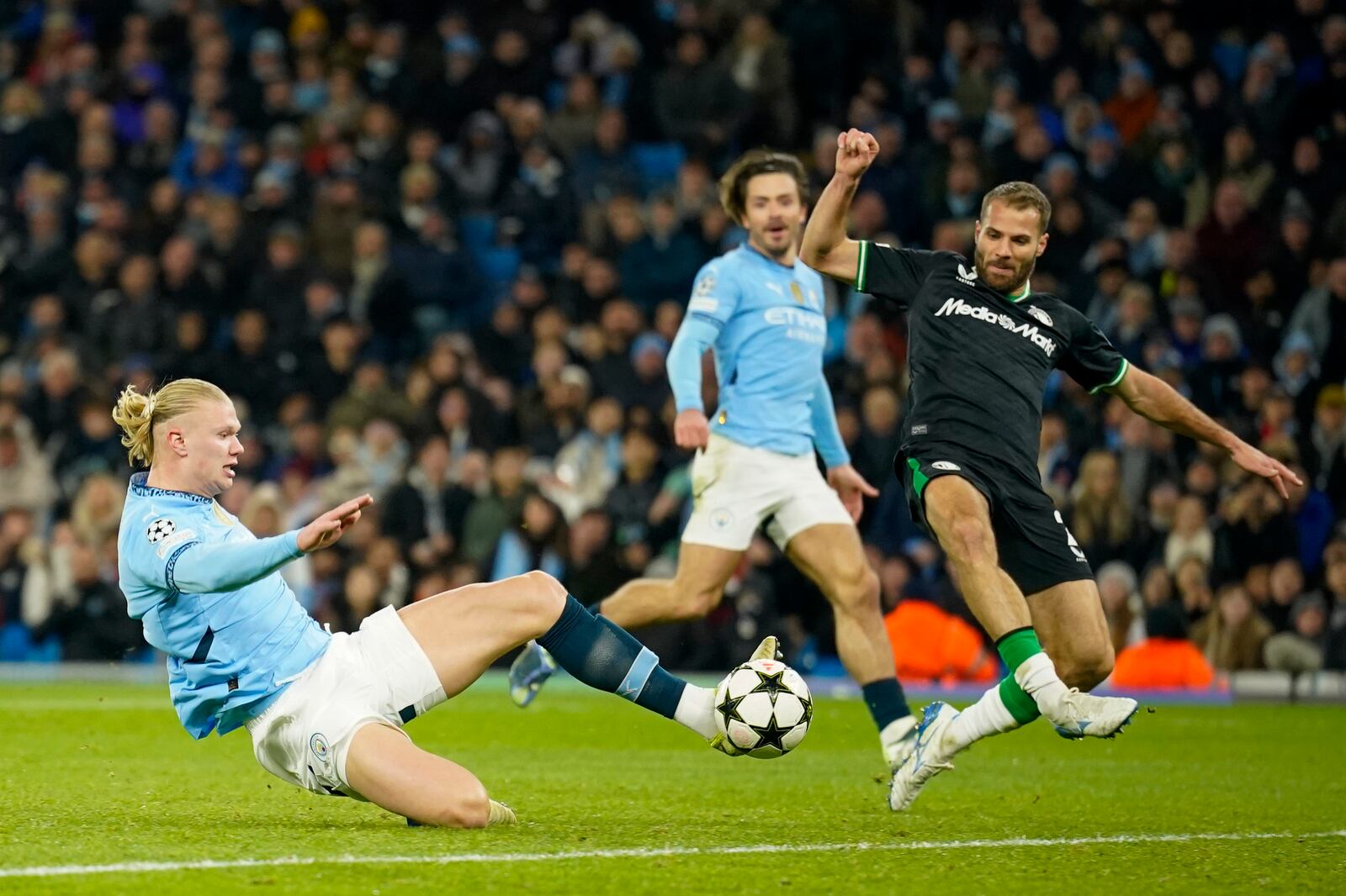 Manchester City's Erling Haaland scores his side's third goal during the Champions League opening phase soccer match between Manchester City and Feyenoord at the Etihad Stadium in Manchester, England, Tuesday, Nov. 26, 2024. (AP Photo/Dave Thompson)