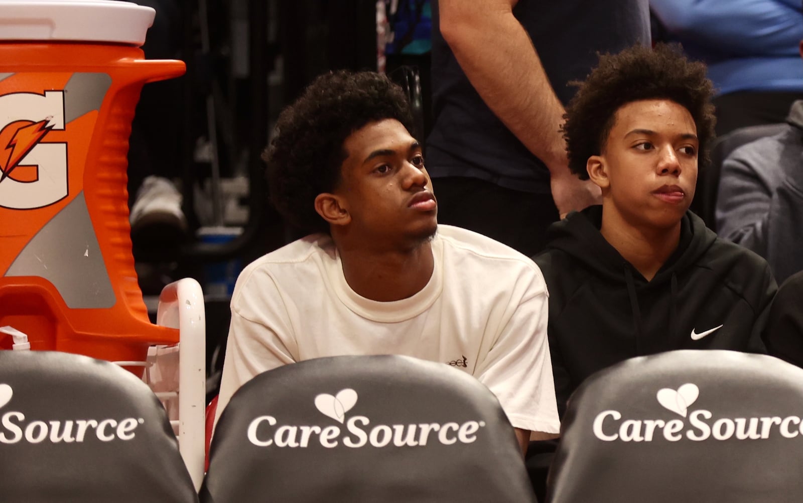 Dayton recruit Jaron McKie, center, sits behind the UD bench during a game against Northwestern on Saturday, Nov. 9, 2024, at UD Arena. David Jablonski/Staff