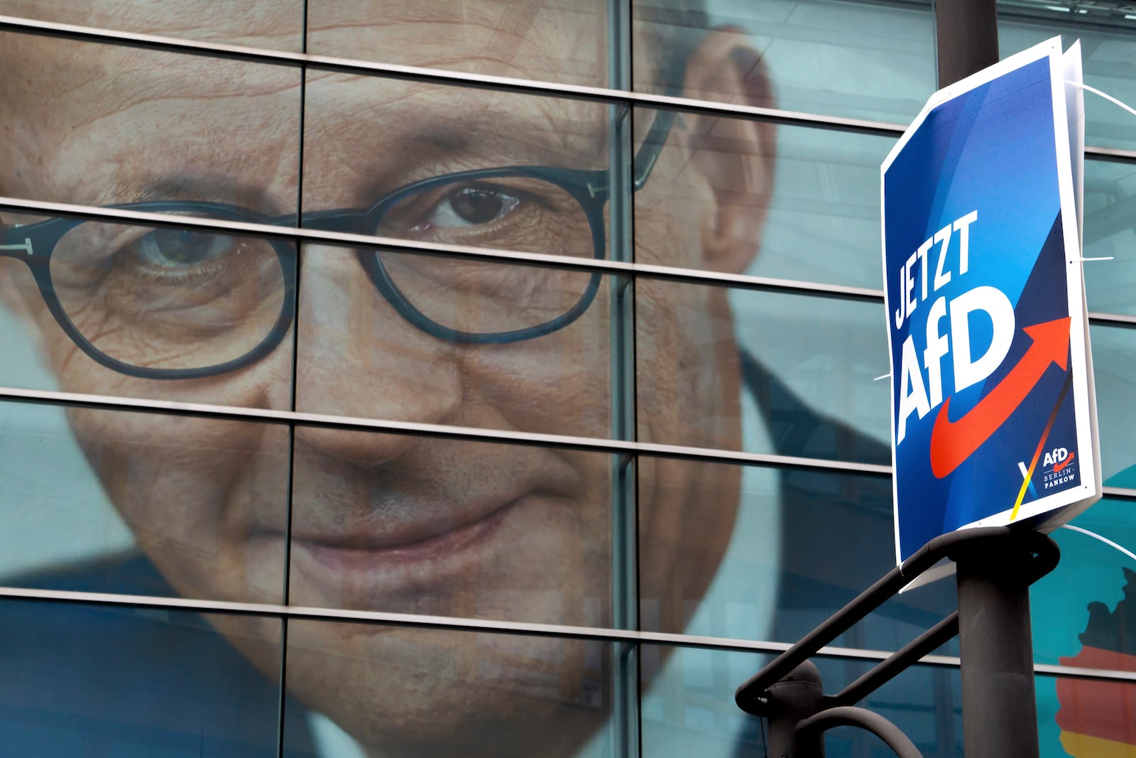 FILE - An election poster of the German far right Alternative for Germany party (AfD), right, is attached to a lamppost in front of a giant election poster showing the chairman of the German Christian Democratic Party (CDU) Friedrich Merz, at the CDU headquarters in Berlin, Germany, Jan. 29, 2025. Slogan reads: 'Now AfD'. (AP Photo/Michael Sohn, File)