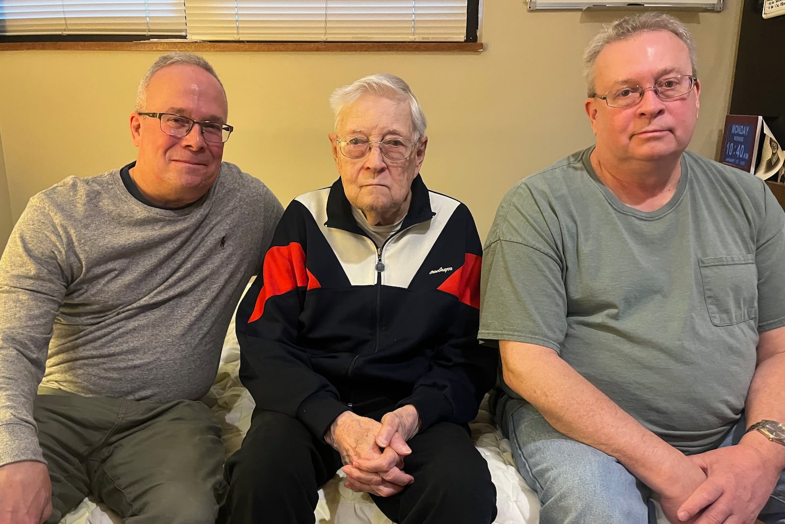 Former Journal Herald and Dayton Daily News sports writer Jim Zofkie, center, poses for a photo with his sons Tim, left, and Mike, on Monday, Jan. 27, 2025, in Centerville. David Jablonski/Staff