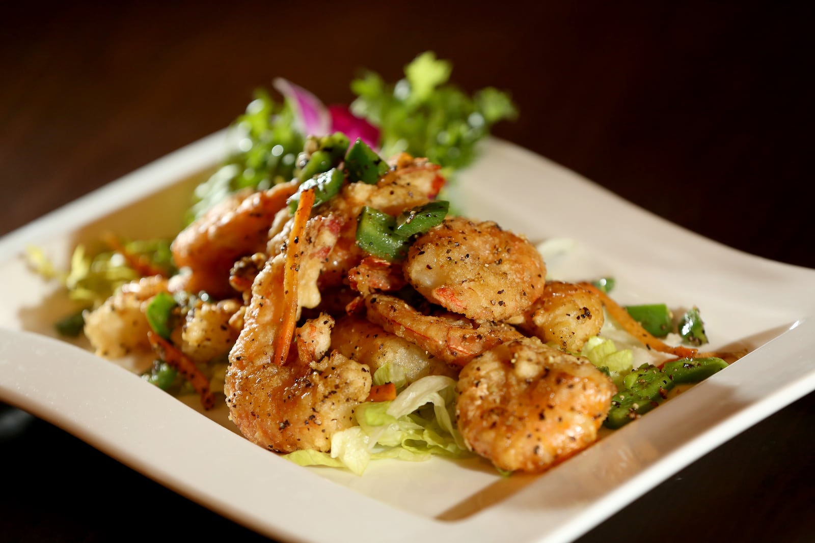 Salt and Pepper Shrimp, served with green pepper and jalepeno, is a Chinese specialty at Ozu 852. The restaurant has won the Best Asian Food category in the Best of Dayton contest for numerous years. Located at 852 Union Blvd. in Englewood, the restaurant is known for fresh, quality sushi, hibachi, Chinese and Japanese foods.  LISA POWELL / STAFF