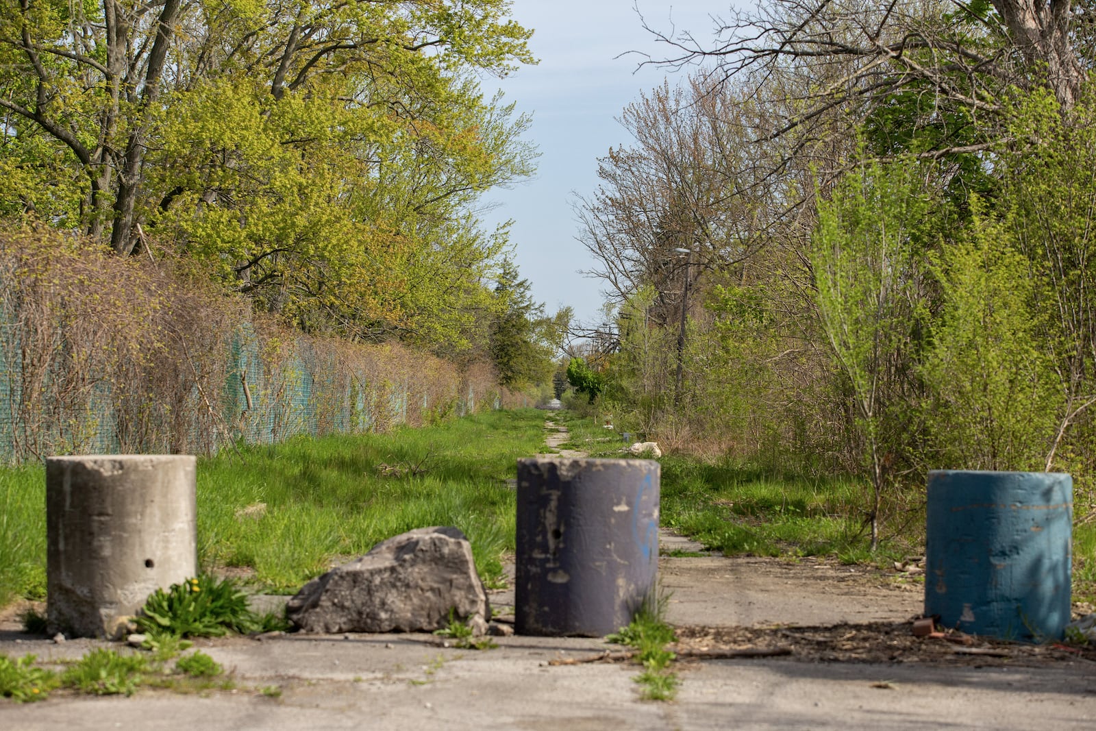 Barriers block access to an area bordering the Love Canal landfill site in Niagara Falls, N.Y., May 11, 2023. Love Canal was one of the nation’s worst toxic waste catastrophes and now — 45 years later — the site for a new, and sometimes unknowing, generation of homesteaders. (Lauren Petracca/The New York Times)
                      