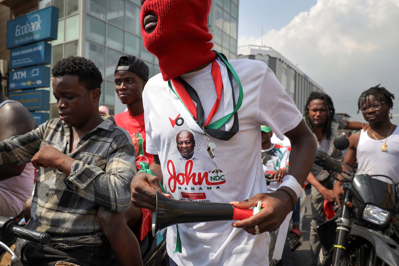 Supporters of opposition candidate and former President John Dramani Mahama celebrate their victory after Ghana's vice president and ruling party candidate, Mahamudu Bawumia conceded his defeat in Accra, Ghana, Sunday, Dec. 8, 2024. (AP Photo/Misper Apawu)