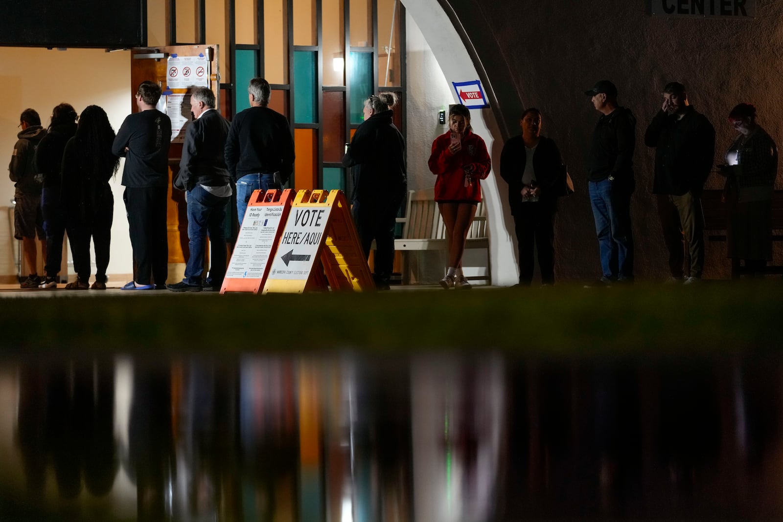 Voters stand in line outside a polling place at Madison Church, Tuesday, Nov. 5, 2024, in Phoenix, Ariz. (AP Photo/Matt York)