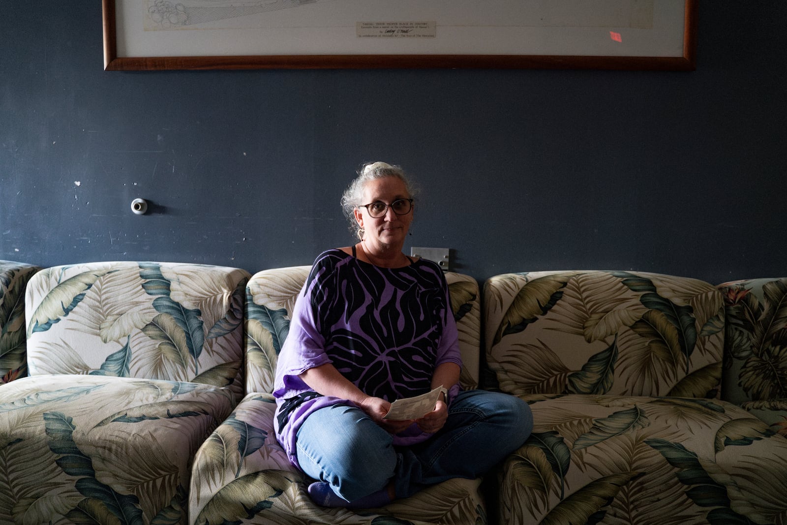 Pam Walton, a former “Two by Twos” sect member who helps track movements of allegedly predatory spiritual leaders through photographs and documents, poses for a portrait at a library Monday, Dec. 9, 2024, in Wailea, Hawaii. Walton said, “Victims and survivors are finally being able to use their voices and bring their perpetrators out from hiding if they choose to do so." (AP Photo/Mengshin Lin)