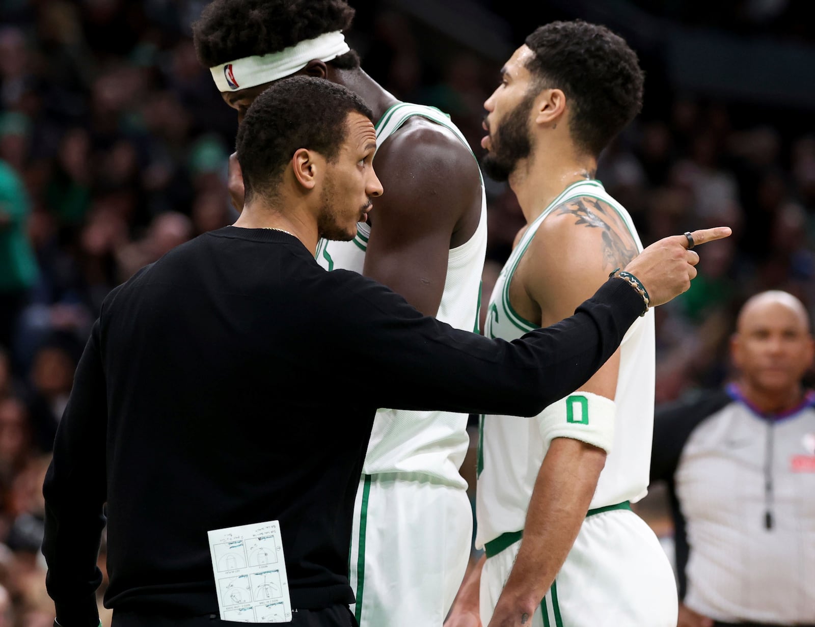 Boston Celtics head coach Joe Mazzulla, left, points during a timeout during the second half of an NBA basketball game against the Memphis Grizzlies, Saturday, Dec. 7, 2024, in Boston. (AP Photo/Mark Stockwell)