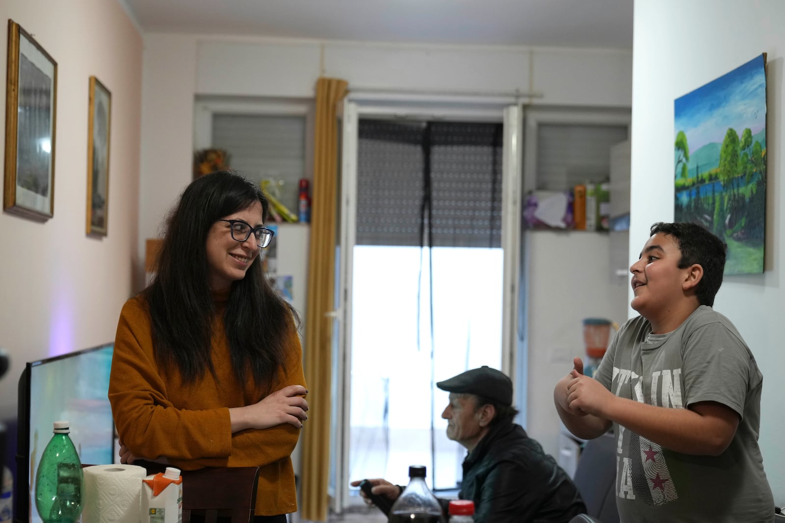 Nour Essa smiles with her son Riad in their house in Rome, Sunday, March 2, 2025. (AP Photo/Alessandra Tarantino)