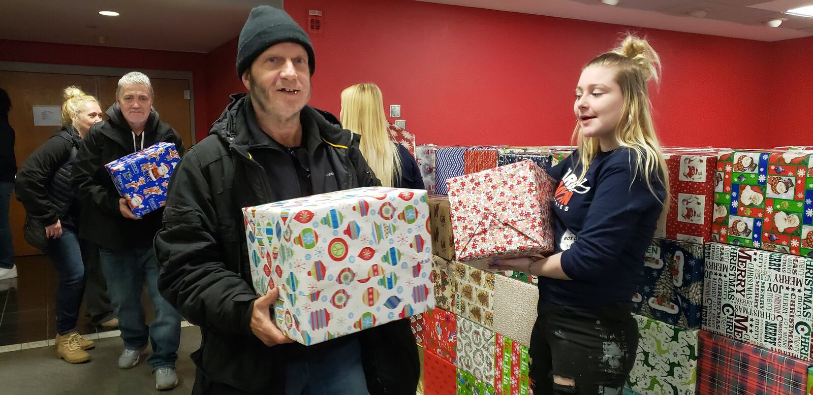 Target Dayton Ministries held its Christmas service at the Dayton Convention Center Wednesday, Dec. 25, 2019, and volunteers greeted attendees as they entered the venue, then worked to distribute 2,200 box lunches and gift boxes as they exited. ERIC SCHWARTZBERG/STAFF