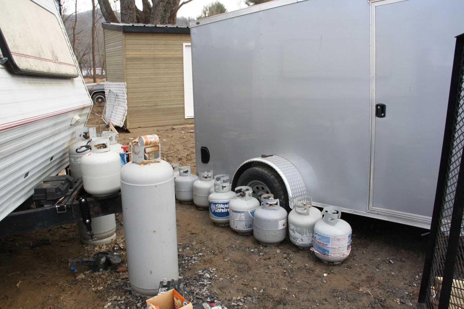 A row of propane tanks sits along the side of Danny Bailey's trailer in Swannanoa, N.C., on Thursday, Feb. 6, 2025. (AP Photo/Makiya Seminera)