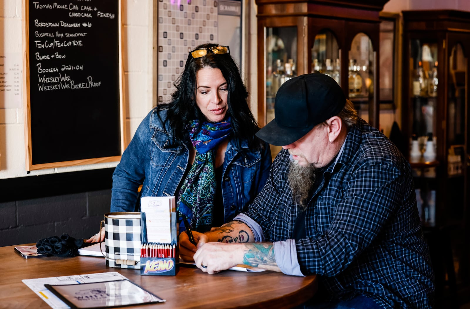 United Front Films along with M5 Entertainment, cast and local extras film scenes for the movie "A Bachelor's Valentine" Wednesday, Jan. 26, 2022 at White Dog Saloon & Distilling Company in Middletown. Director Lana Read, left, and cinematographer Christopher Maggard go over a scene. NICK GRAHAM / STAFF