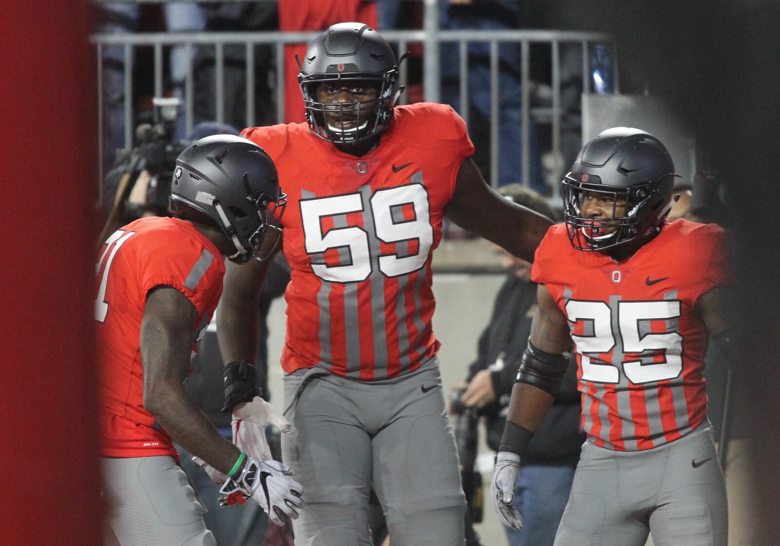 Ohio State's Mike Weber, right, celebrates a touchdown with Isaiah Prince (59) and Parris Campbell, left, in the first half against Nebraska on Saturday, Nov. 5, 2016, at Ohio Stadium in Columbus. David Jablonski/Staff