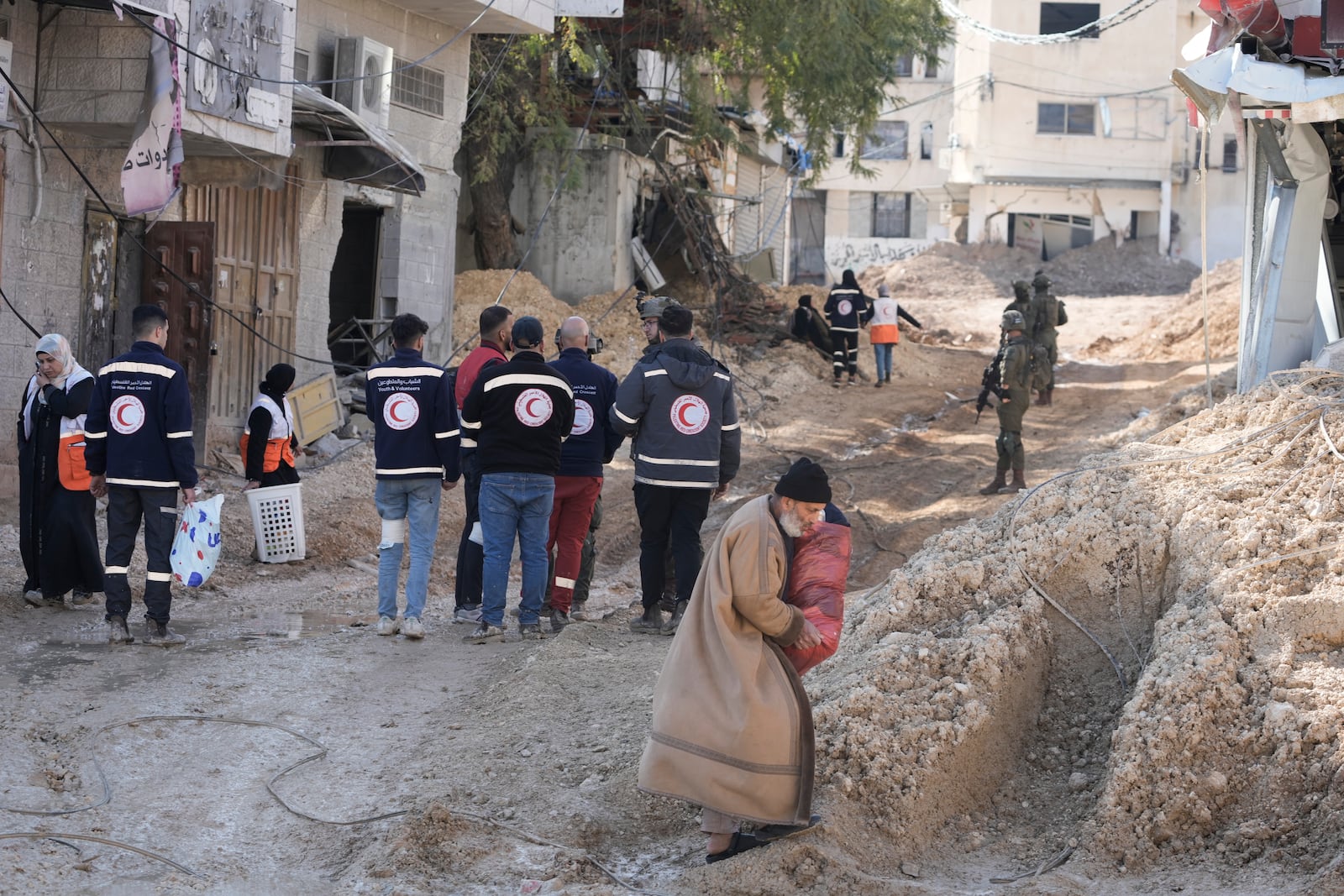 Residents of the West Bank urban refugee camp of Nur Shams evacuate their homes and carry their belongings as the Israeli military continues its operation in the area on Wednesday, Feb. 26, 2025. (AP Photo/Majdi Mohammed)